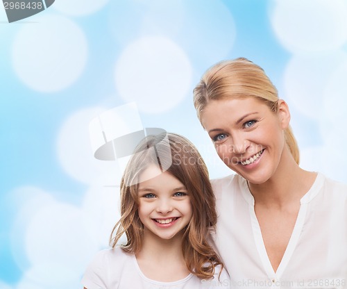Image of smiling mother and little girl