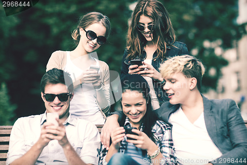 Image of students looking at smartphones and tablet pc