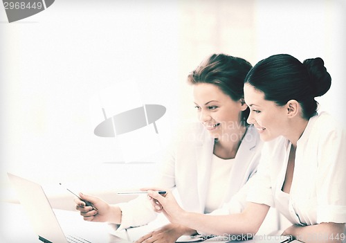 Image of businesswomen working with laptop in office