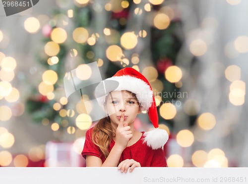 Image of smiling little girl in santa helper hat