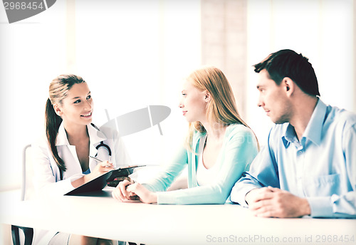 Image of doctor with patients in cabinet