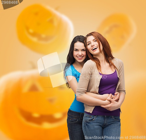 Image of smiling teenage girls hugging