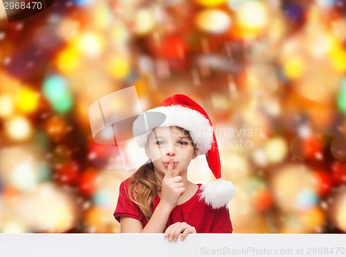 Image of smiling little girl in santa helper hat