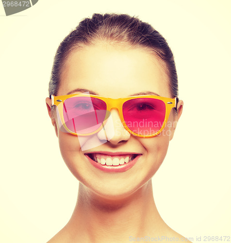 Image of smiling teenage girl in pink sunglasses