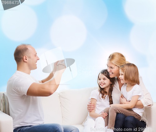 Image of happy family with camera at home