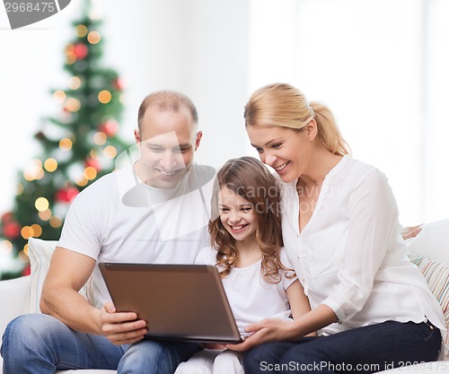 Image of happy family with laptop computer