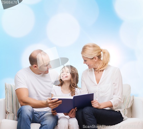 Image of happy family with book at home