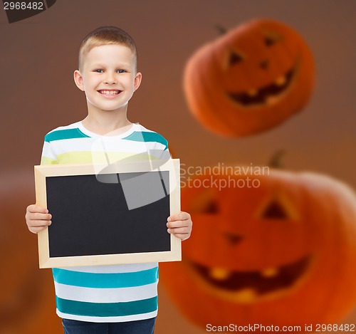 Image of smiling little boy with black board