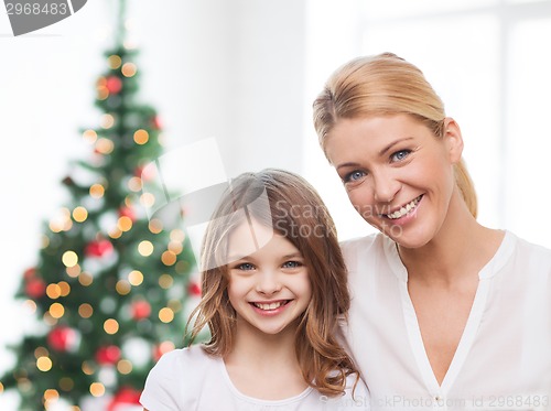 Image of smiling mother and little girl