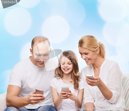 Image of happy family with smartphones