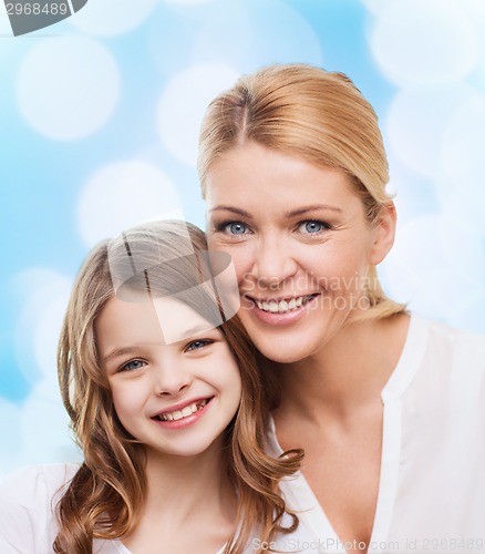 Image of smiling mother and little girl