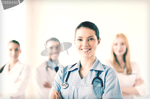 Image of female doctor in front of medical group