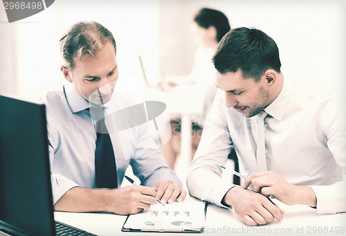 Image of businessmen with notebook on meeting