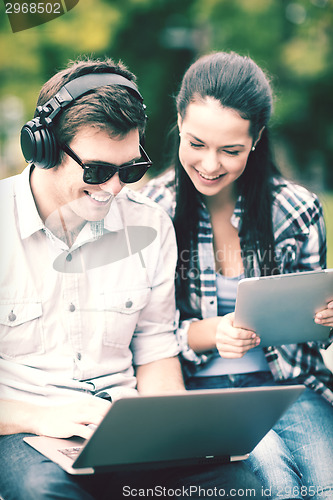 Image of students or teenagers with laptop computers