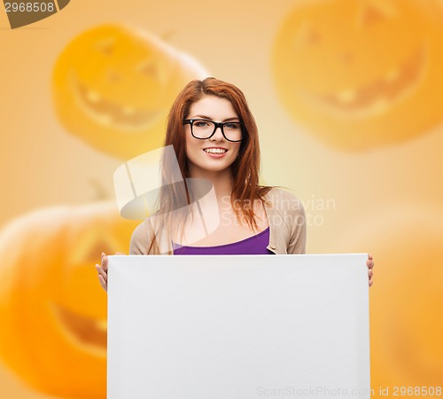 Image of smiling teenage girl in glasses with white board