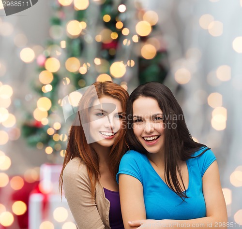 Image of smiling teenage girls hugging