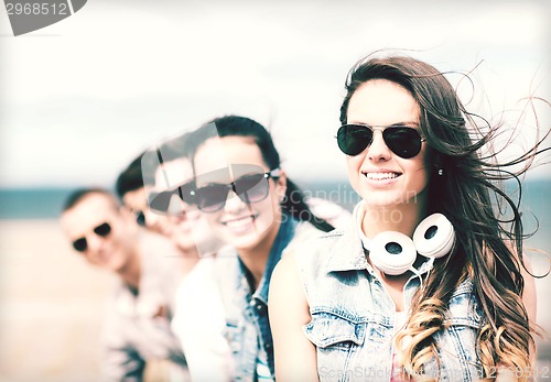 Image of teenage girl with friends outside