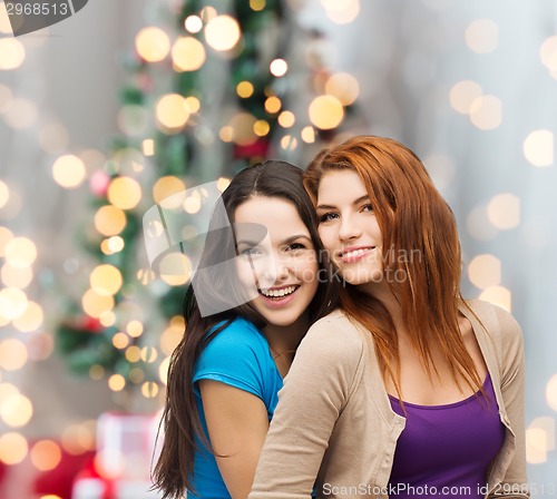 Image of smiling teenage girls hugging