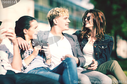 Image of students looking at smartphones and tablet pc