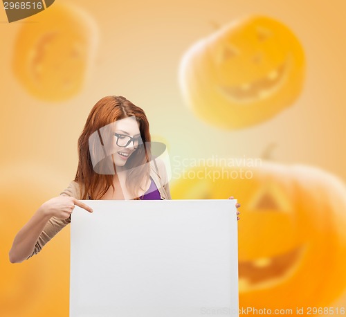 Image of smiling teenage girl in glasses with white board