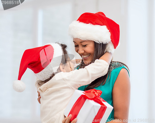 Image of happy mother and child girl with gift box