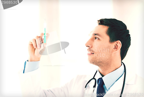 Image of male doctor holding syringe with injection