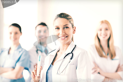 Image of female doctor holding syringe with injection