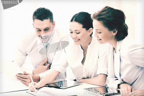 Image of business team working with tablet pcs