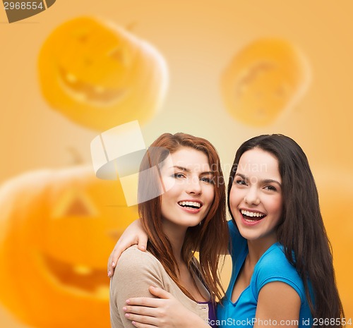 Image of smiling teenage girls hugging