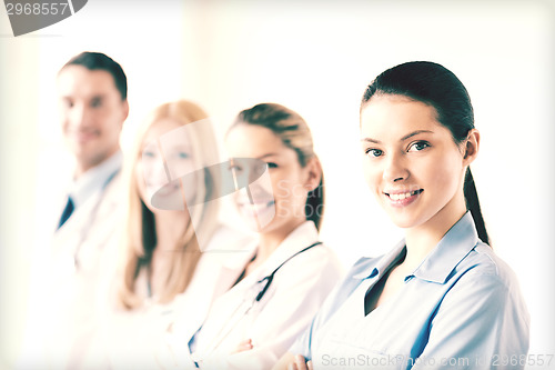 Image of female doctor in front of medical group