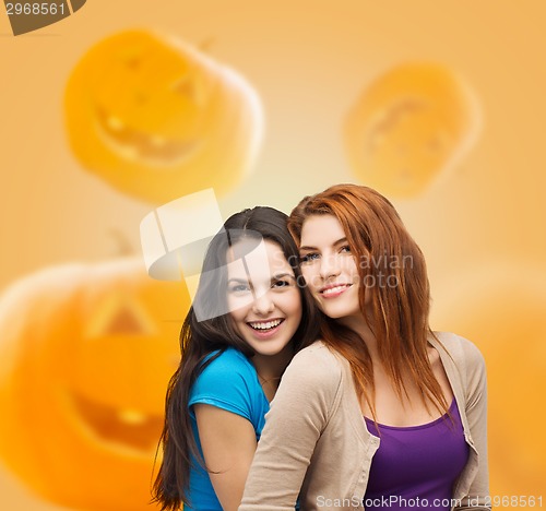 Image of smiling teenage girls hugging