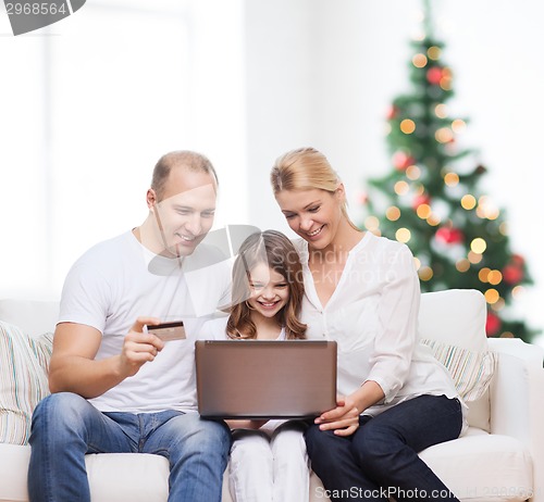 Image of happy family with laptop computer