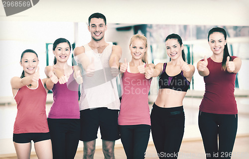 Image of group of people in the gym showing thumbs up