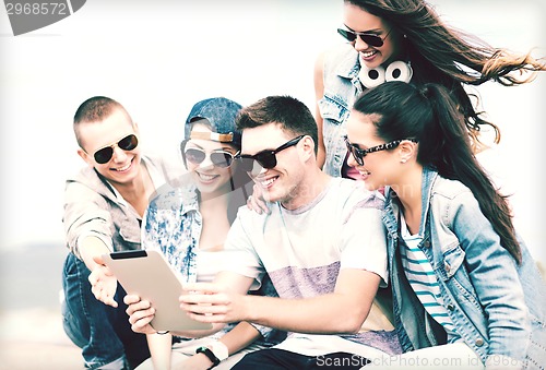 Image of group of teenagers looking at tablet pc