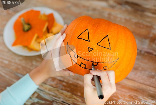 Image of close up of woman with pumpkins at home