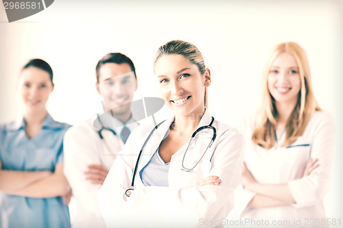 Image of female doctor in front of medical group