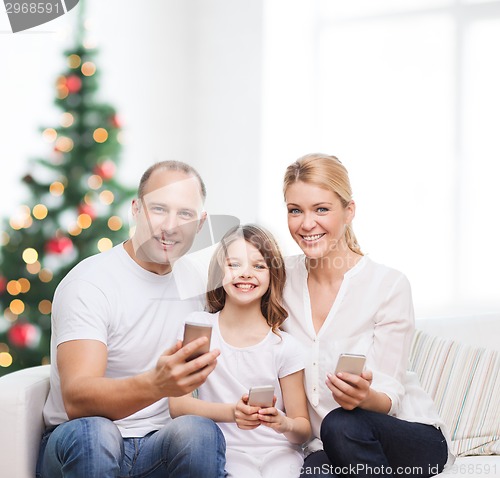 Image of happy family with smartphones