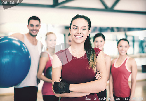 Image of woman standing in front of the group in gym