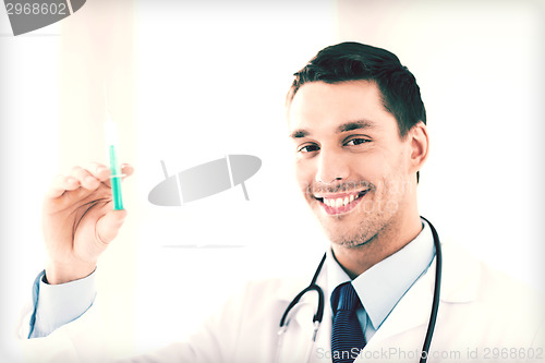 Image of male doctor holding syringe with injection