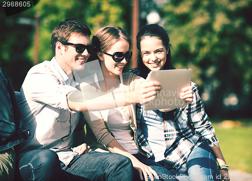 Image of teenagers taking photo outside