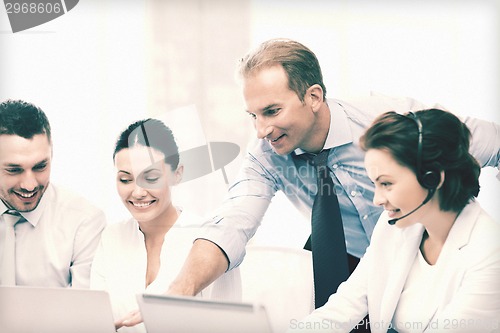 Image of group of people working in call center