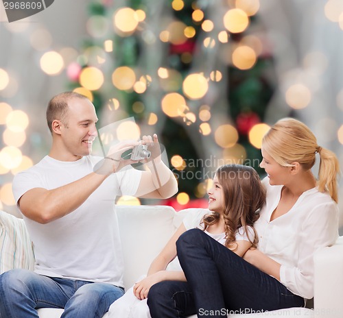 Image of happy family with camera at home