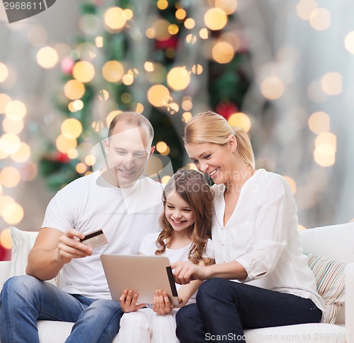 Image of happy family with tablet pc and credit card
