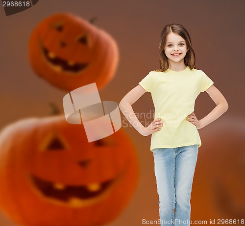 Image of smiling girl over pumpkins background