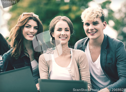 Image of students or teenagers with laptop computers