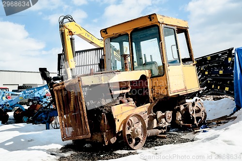 Image of Old tractor among new equipment. Tyumen. Russia