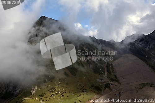 Image of Ski slope in autumn and a cloud