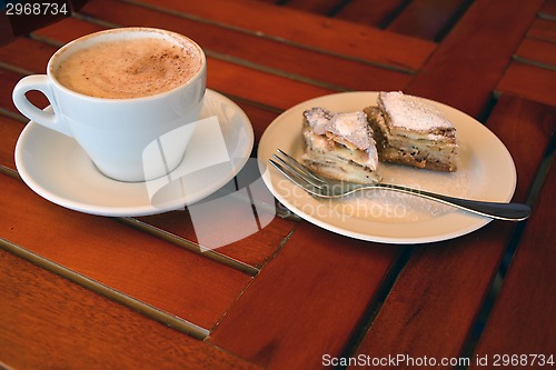 Image of A cup of black coffee with baklava