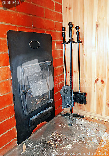 Image of Set of cast iron objects near the stove in the Russian bath