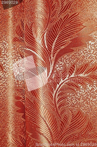 Image of Texture of red and beige satin patterned curtains with folds